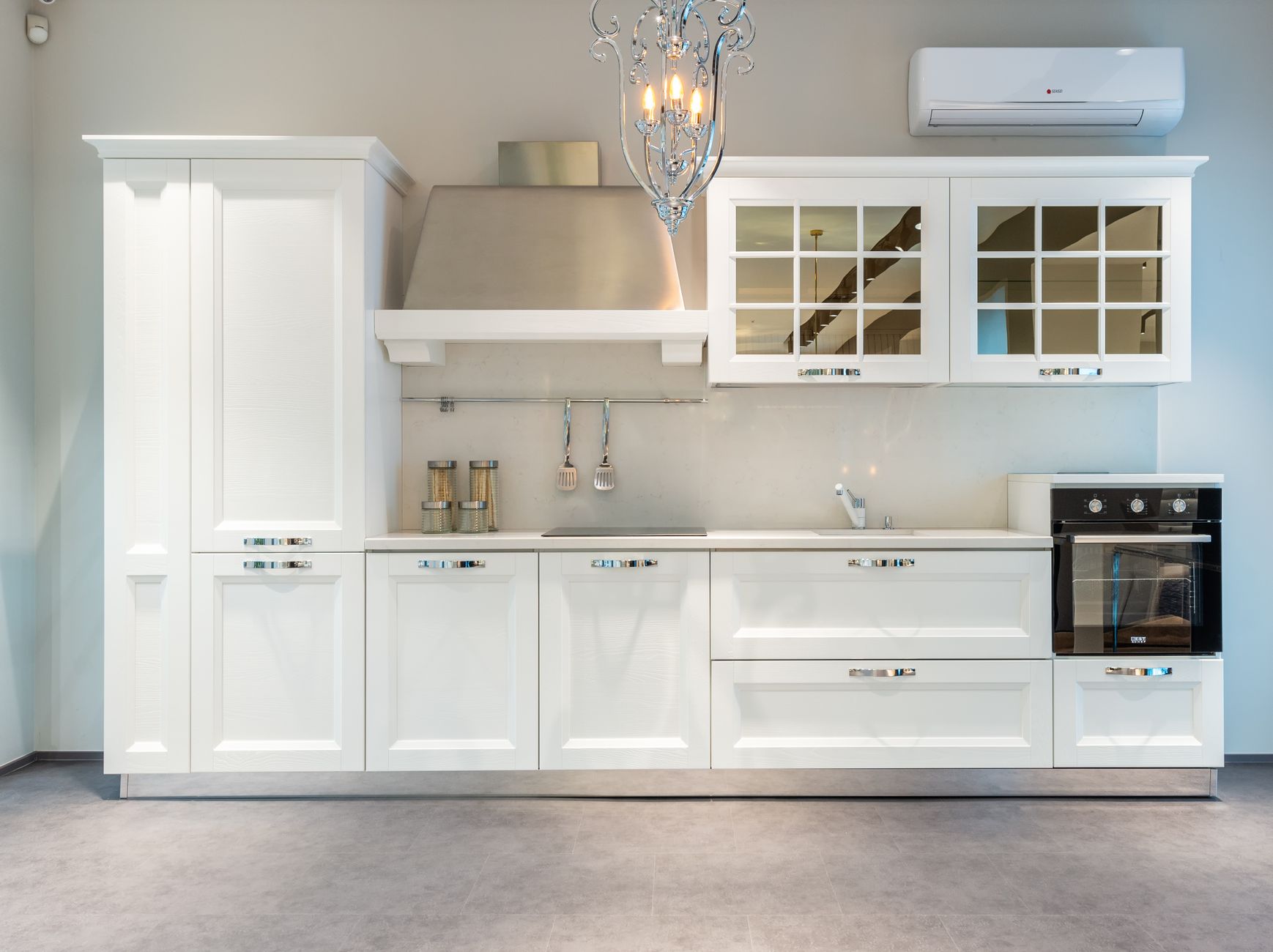 Interior of modern furnished kitchen with elegant white cabinets and contemporary appliances in spacious in Austin, TX